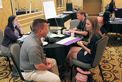 Participants have discussions around the table. Participants have discussions around the table.