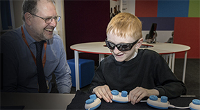 An instructor and a blind student with some technology. An instructor and a blind student with some technology.
