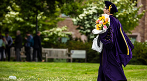 A PhD graduate walks to their ceremony. A PhD graduate walks to their ceremony.