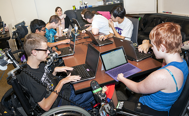 A diverse group of students working on individual computing projects