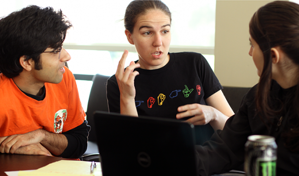 A TA interprets between a deaf computing student and a hearing TA. A TA interprets between a deaf computing student and a hearing TA.