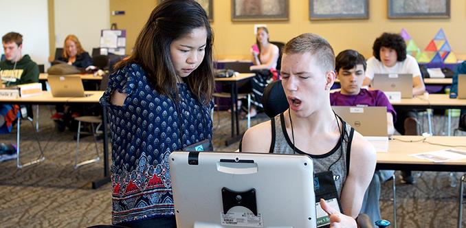 Two students with disabilities work together on the computer.