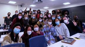 
Still showing a group smiling at the camera.