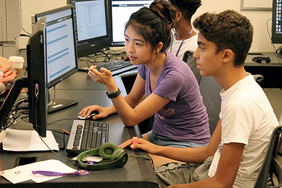 An instructor shows a student how to fix a problem in Quorum.