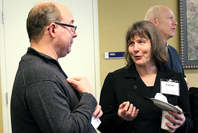 Two participants discuss over lunch.